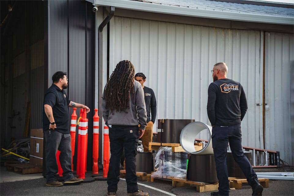 The Medford Elite Gutters team is standing around discussing the plans for the day.
